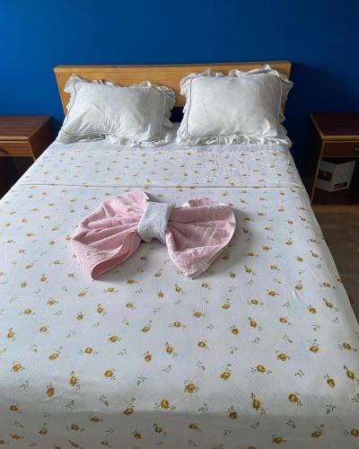 a bed with a robe and a bow tie on it at Casa Ze & sonia in Portela