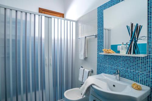 uma casa de banho com um WC, um lavatório e um chuveiro em B&B Pietre Preziose em Castelluzzo