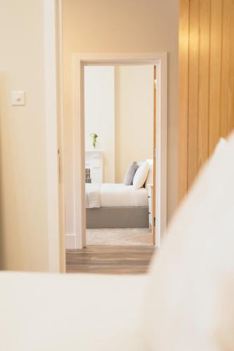 a view of a bedroom with a bed through a mirror at The Milkmans Residence in Bournemouth