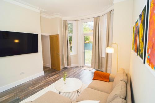 a living room with a couch and a table at The Milkmans Residence in Bournemouth