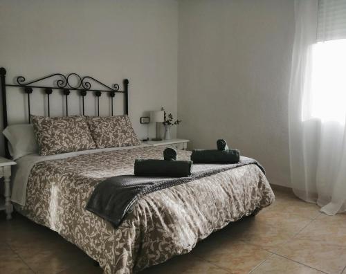 a bedroom with a bed with two pillows on it at Sueños de Córdoba in Córdoba