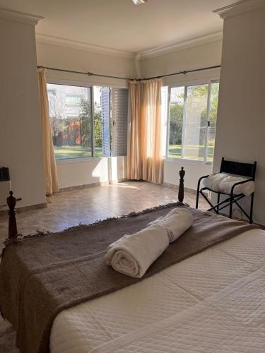 a bedroom with a bed with a towel on it at Gualeguaychú Golf y verdes in Gualeguaychú