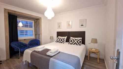 ポルトにあるMerc Porto Ribeira's Viewのベッドルーム1室(大型ベッド1台、青い椅子2脚付)