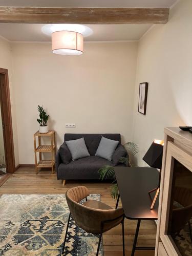 a living room with a couch and a table at Pilsētas Māja- guest house in Dobele city center in Dobele