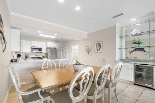 a kitchen and dining room with a wooden table and chairs at Marlin Key 4F in Orange Beach