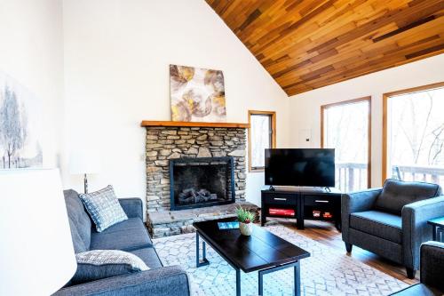 a living room with a couch and a fireplace at River Front Resort in Elkins