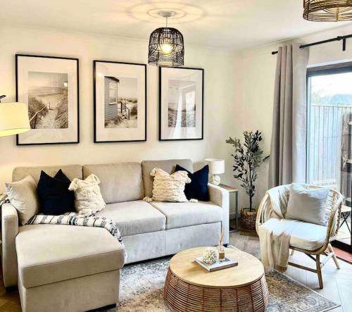 a living room with a couch and a table at The Nook - Cosy coastal retreat near Sandbanks in Poole