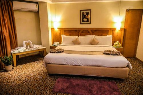 a bedroom with a large bed in a hotel room at Katriya Hotel and Tower in Hyderabad