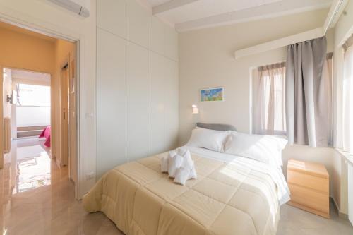 a white bedroom with a large bed with white pillows at Casa Umberto I , Taormina Centro in Taormina