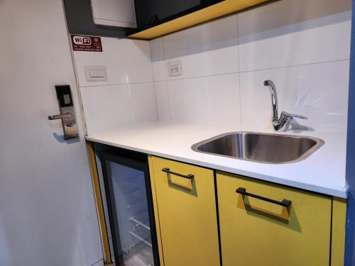 a kitchen with a sink and a counter top at Amdar Hostel in Eilat