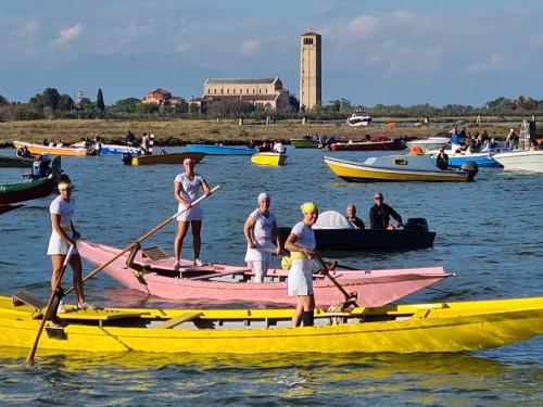 a group of people on boats in the water at Ca' Nova - Burano in Burano
