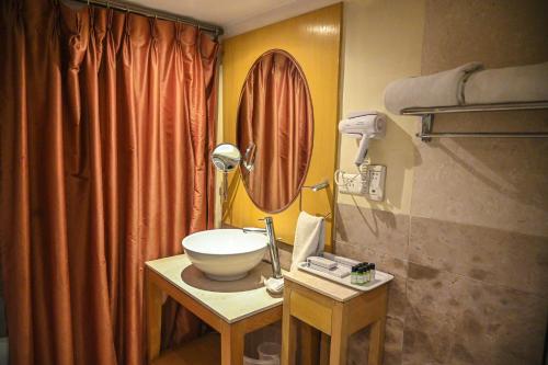 a bathroom with a sink and a mirror at Katriya Hotel and Tower in Hyderabad