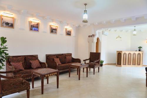 una sala de estar con sofás y mesas. en Hotel ASL, en Bukhara