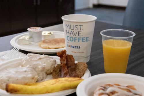 a plate of breakfast food and a cup of orange juice at Holiday Inn Express & Suites New Martinsville by IHG in New Martinsville
