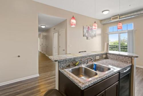 a kitchen with a sink and a counter top at Cozy Indy Get Away - Private Room - Shared in Indianapolis