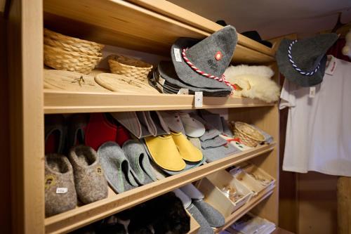 a closet filled with lots of shoes and hats at Holiday chalet "ALPINE DREAMS" with PRIVATE WELLNESS in Solčava