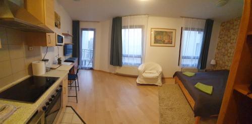 a room with a kitchen and a living room at Princess and Prince Apartman in Budapest