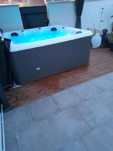 a large bath tub sitting on a wooden floor at Chambres 2 caps in Ambleteuse
