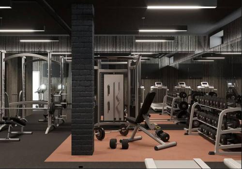 a gym with rows of chairs and machines at Modern Spacious Apartment in Chelsea in New York