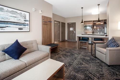 a living room with a couch and a table at Candlewood Suites Sioux Falls, an IHG Hotel in Sioux Falls
