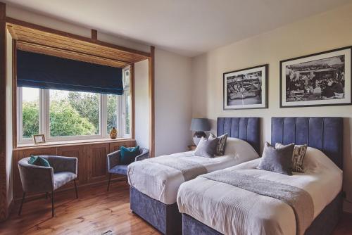 a bedroom with two beds and a window at The Old Vicarage in Holmrook