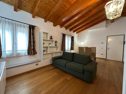 a living room with a green couch and a table at NG Guest House il RIS in Sassari