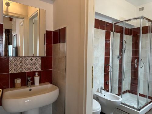 a bathroom with a sink and a toilet and a shower at NG Guest House il RIS in Sassari