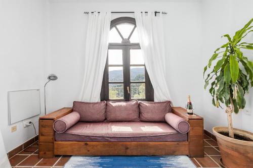 a couch in a living room with a window at Cerro de Hijar in Tolox