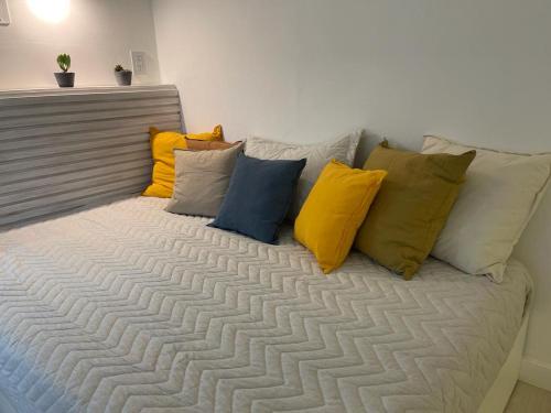 un montón de almohadas sentadas en una cama en Divine studio super bright with balcony en Buenos Aires