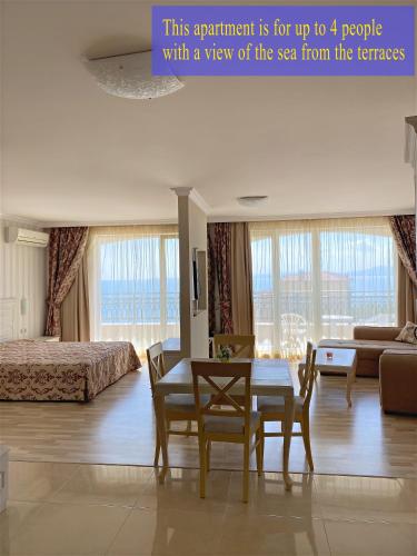 a room with a bed and a table and chairs at Private Super apartments by sea in Apart Hotel ! in Pomorie