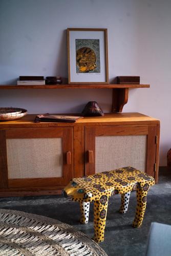 a desk with a leopard print stool next to a table at Casa Rosa Atins in Atins
