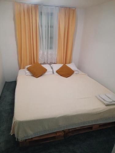 a bed in a room with a window at Cabana in poiana padurii in Recaş
