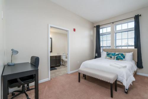 a bedroom with a bed and a desk and a window at Private Bedroom Downtown INDY - Shared in Indianapolis