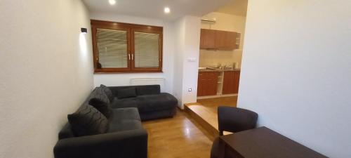 a living room with a couch and a table at Beautiful View Of Sarajevo Center in Sarajevo