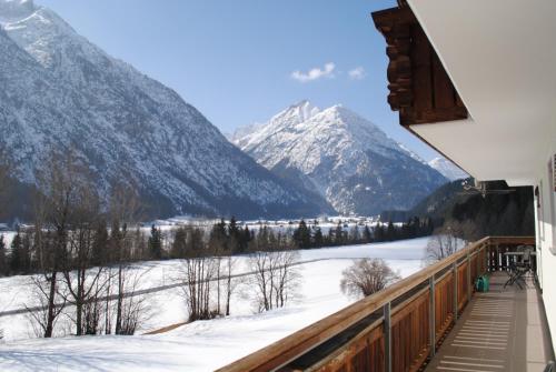 a view from the balcony of a house with snow covered mountains at Gästehaus Hauser in Bach