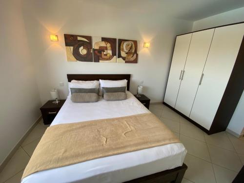 a bedroom with a large bed with two pillows at Apartments at Melia Beach Resort & Spa in Santa Maria