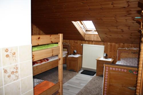 a room with two bunk beds and a skylight at Haus Veronika in Wegscheid
