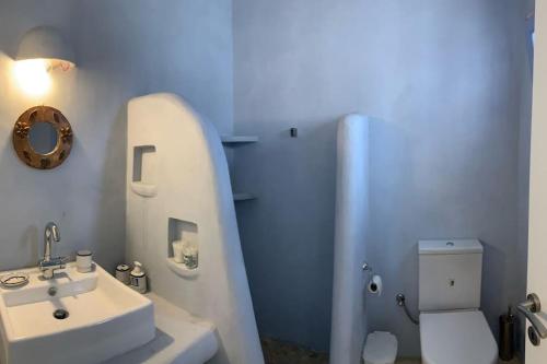 a white bathroom with a sink and a toilet at Villa Laugh, on The Limnes Beach in Kampos Paros