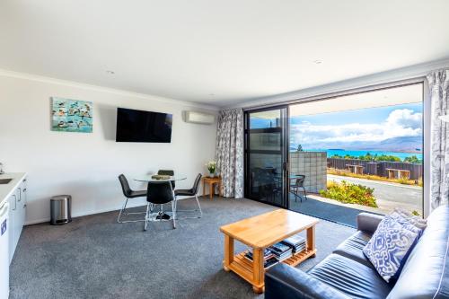 a living room with a couch and a table at Roto View - Beautiful views of Lake Tekapo in Lake Tekapo