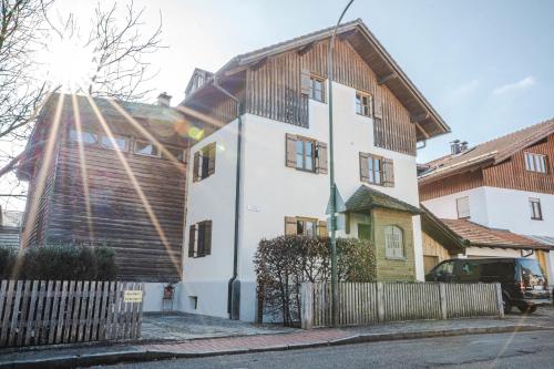 a large white house with a wooden roof at Naturhaus Luminus in Bad Aibling