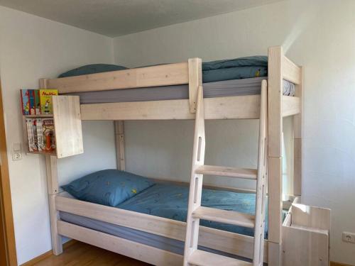 two bunk beds in a room with a ladder at Allgäuer Dorfleben in Missen-Wilhams