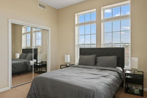 a bedroom with a large bed and a mirror at Your Summer Get Away with GYM in Indianapolis