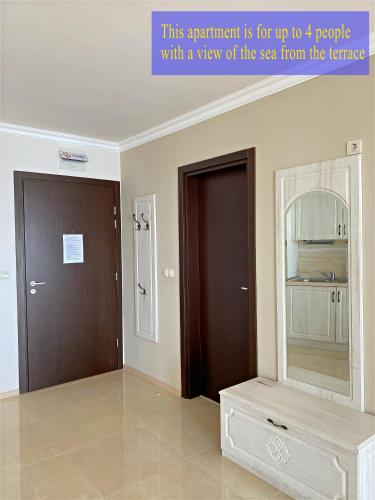a room with two doors and a mirror on the wall at Private Super apartments by sea in Apart Hotel ! in Pomorie