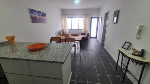 a kitchen and a living room with a table at Tia Nita Apartamentos in Mindelo