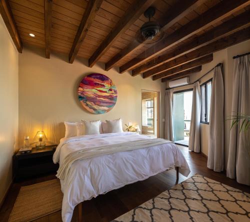 a bedroom with a large bed and a large window at Panorama de la Parroquia in San Miguel de Allende