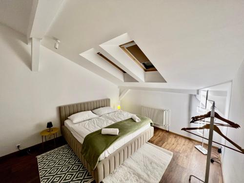 a bedroom with a bed and a skylight at Aneri Apartment Old Town in Bratislava