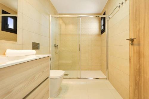 a bathroom with a shower with a toilet and a sink at Premium Apartment with Swimming pool by Aparters in Arenales del Sol