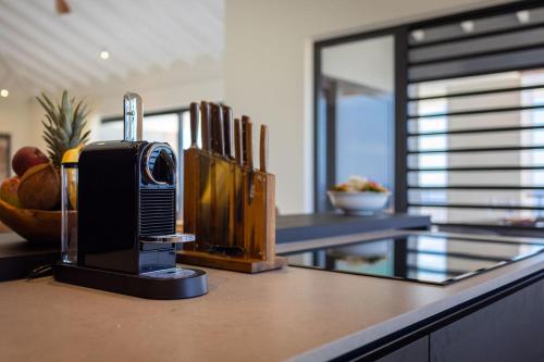 a kitchen counter with a coffee maker on top of it at Coral Estate Ocean View Apartments in Willemstad