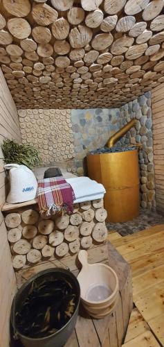 a room with a fire pit and a pile of logs at Villa Space in Gonio