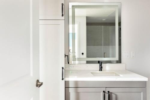 a white bathroom with a sink and a mirror at Hillcrest 1br w gym wd pool nr bars shops SAN-9 in San Diego